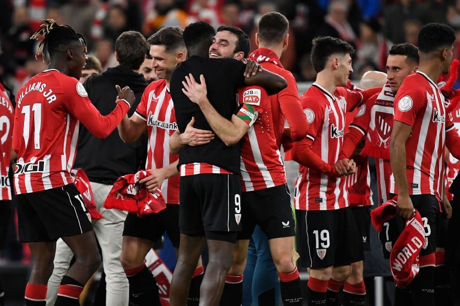Athletic Bilbao players celebrate their victory at the end of the Spanish Copa del Rey (King's Cup) semi final second leg football match between Athletic Club Bilbao and Club Atletico de Madrid at the San Mames stadium in Bilbao. - AFP ppic