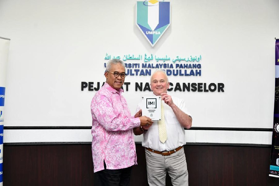 Institute of the Motor Industry external quality assurer Stephen Longworth (right) presenting the International Approved Centre certificate to UMPSA Vice-Chancellor Professor Datuk Dr Yuserrie Zainuddin at the Pekan campus in Pahang. PIC COURTESY OF UMPSA