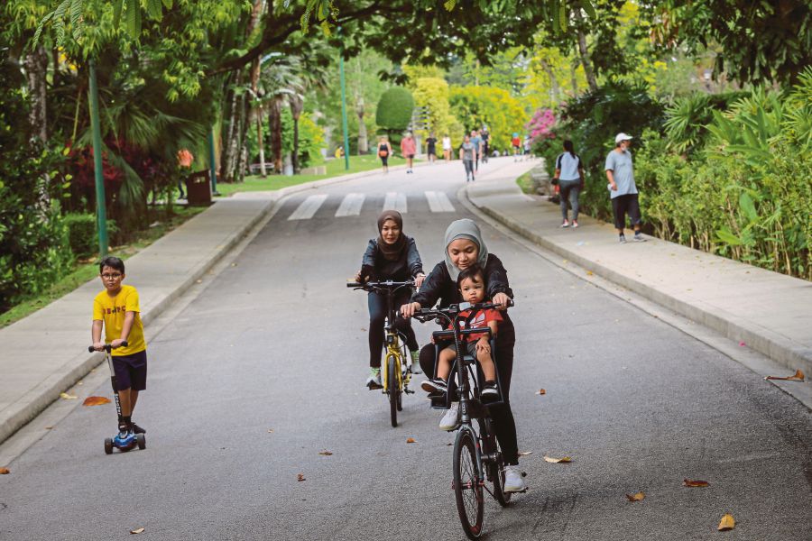 People jogging, walking and cycling at the Perdana Botanical Gardens in Kuala Lumpur yesterday. -NSTP/ASYRAF HAMZAH