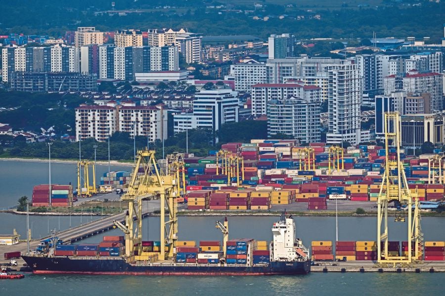 A file picture showing a cargo vessel docked at a port in Butterworth on the mainland Malaysian peninsular as seen from Penang island on March 10, 2023. - Pic source (AFP) 