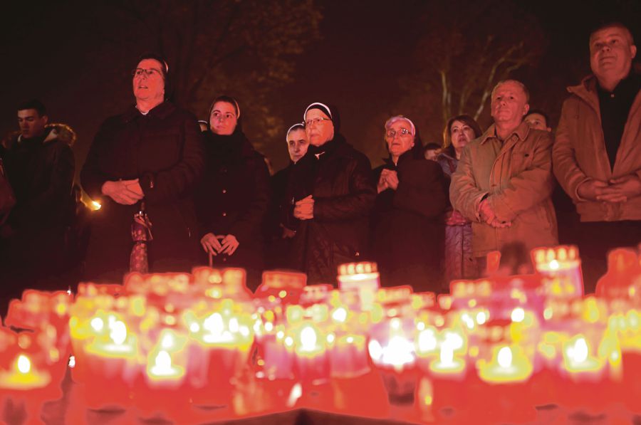 Bosnian Catholic nuns pray and light candles for the convicted general Slobodan Praljak, who killed himself seconds after the verdict in the UN war crimes tribunal in The Hague, in Mostar, Bosnia and Herzegovina. REUTERS