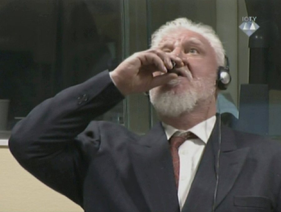 A wartime commander of Bosnian Croat forces, Slobodan Praljak, is seen drinking poison during a hearing at the UN war crimes tribunal in the Hague, Netherlands. REUTERS