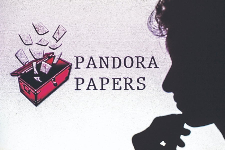 This illustration shows a woman’s shadow cast on the logo of Pandora Papers. More than 100 billionaires, 29,000 offshore accounts and 336 politicians were named in the first Pandora Papers leaks on Oct 3, 2021. AFP PIC