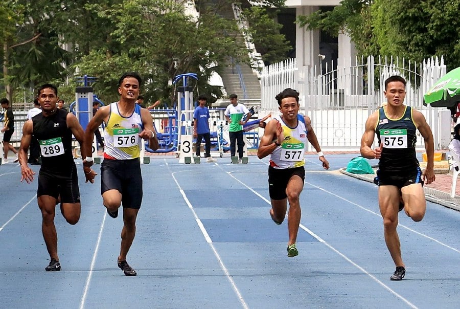 Jonathan Nyepa (right) wins the men’s 100m gold medal at the FT All Comers Athletics Championships in Bukit Jalil today. Pic by Amirudin Sahib