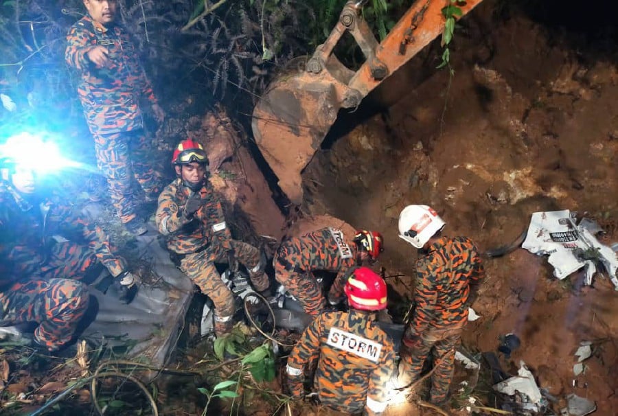 Rescuers have located the second vehicle, a Toyota Vellfire, buried underneath debris following a landslide at FT185 of Jalan Simpang Pulai - Blue Valley in Simpang Pulai here today. -Pic courtesy of Fire and Rescue Dept
