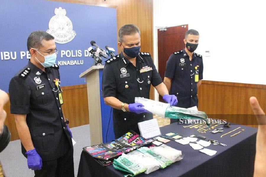 District police chief Assistant Commissioner Mohd Zaidi Abdullah (center) said police detained two men, aged 30 and 32, during the raid. -NSTP/Juwan Riduan