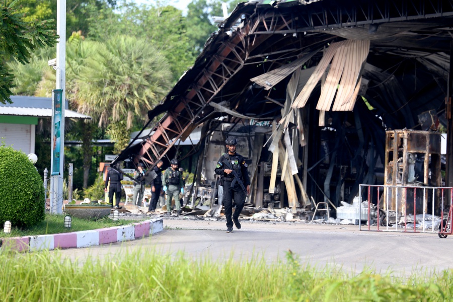 A ranger guarding at a partly damaged gas station after an attack in Nong Chik district in southern Thailand’s Pattani province in Wednesday. Bernama file pic
