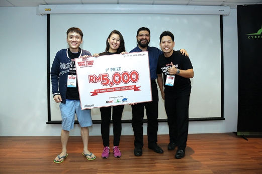 Grand prize winner Team 20 is Leong Yok Tien (left), Adel Maratova and Ng Kok Kwan (right), with Malick Aboobakar (third from left), chief information officer of MDEC.
