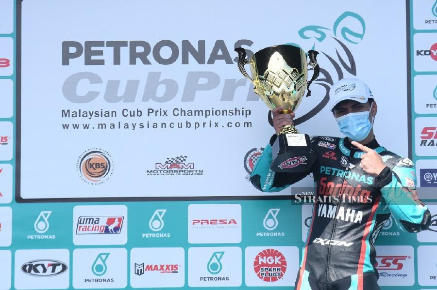 Kasma Daniel Kasmayudin celebrates his victory in the CP150 class at the Petronas Malaysian Cub Prix Championships yesterday. 