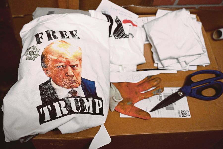 Sales of products with former US president Donald Trump’s arrest photo raised about US$3 million in one week. - AFP pic