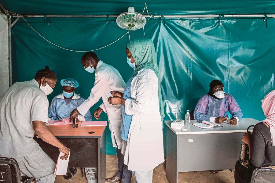 Medics screening patients at Pikine Hospital in Dakar recently as a preventative measure against Covid-19. -AFP pic 