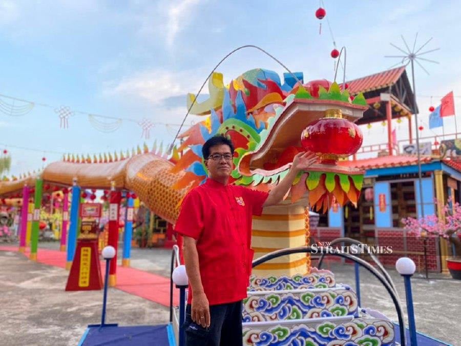 San Sheng Welfare Organisation permanent advisor Pang Hu Kong posing in front of the dragon structure made entirely out of recycled materials at the Cultural Heritage Village in Alor Star. NSTP/AHMAD MUKHSEIN MUKHTAR