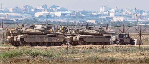 Soldiers sitting atop tanks on the Israeli side of the border with the Gaza Strip. AFP pic
