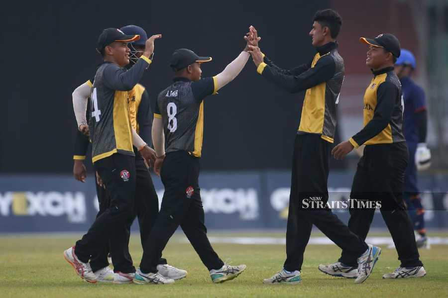 Malaysian players celebrate beating Thailand in a T20I Quadrangular Series match at UKM Oval on Monday. - Pic courtesy of Malaysian Cricket Association
