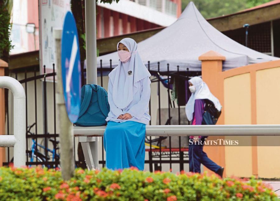 A student outside her school in Kuala Lumpur last week. Covid-19 clusters in educational institutions now make up the bulk of   active clusters in the country. -NSTP/EIZAIRI SHAMSUDIN