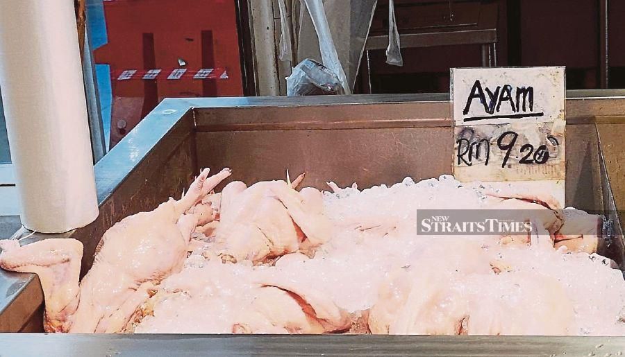 Chicken is sold at RM9.20 per kg at a wet market in Kuching yesterday.  - NSTP/MOHD ROJI KAWI