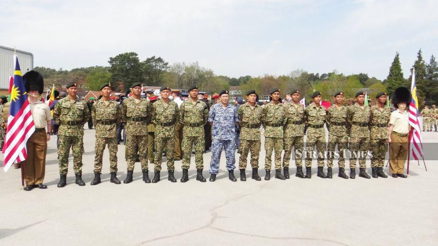 Soldiers from the Royal Malay Regiment’s first battalion posing with Major Hairulnizam Baharuddin, RMAF assistant defence adviser, High Commission of Malaysia, after a rehearsal at the army training centre in Pirbright yesterday. - Pic by Zaharah Othman