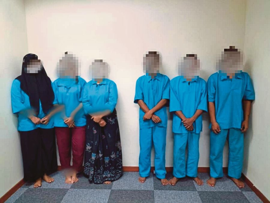 Some of the undocumented foreigners arrested by the Malaysian Maritime Enforcement Agency while travelling in waters off Johor, in various operations that include Op Benteng. PIC COURTESY OF MMEA