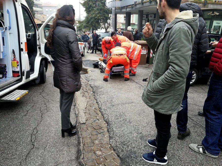 Healthcare personnel take care of an injured person after being shot by gun fire from a vehicle, in Macerata, Italy, February 3, 2018. REUTERS/Stringer NO RESALES NO ARCHIVESTRINGER