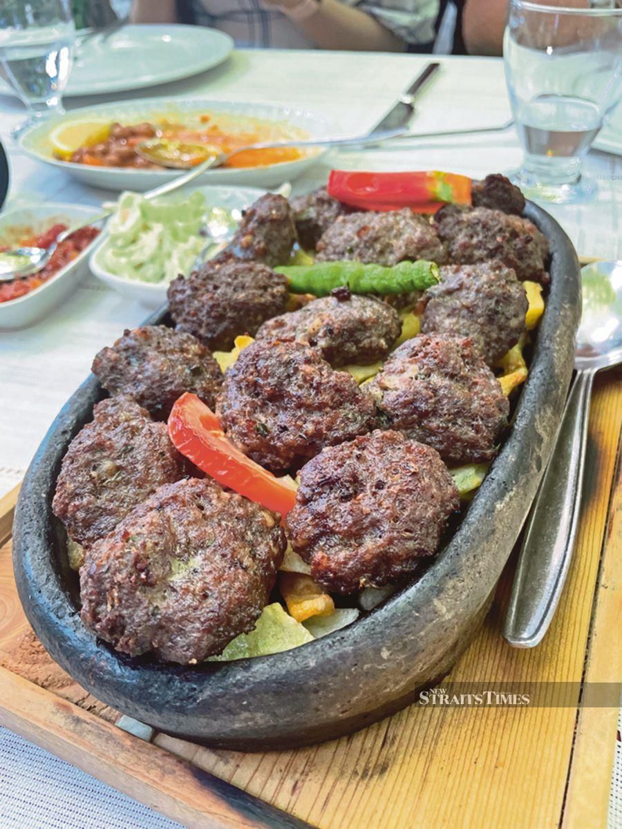 A Greek dish of meatballs and potatoes cooked in the oven.