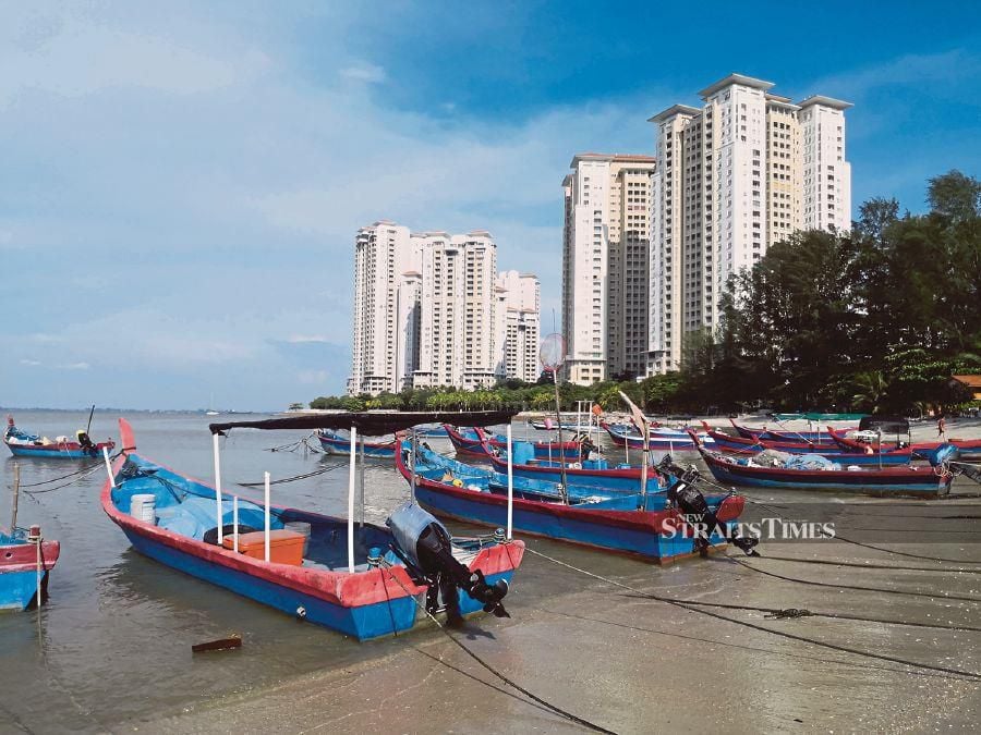Luxury condominiums towering over Tanjong Tokong fishing village. 