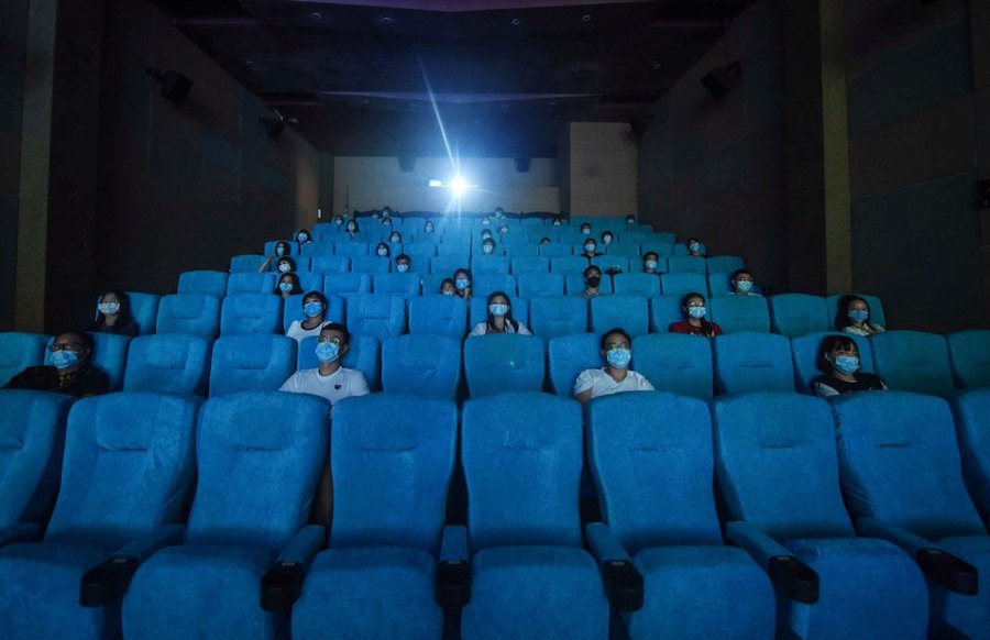 People watch a movie as they sit separately for social distancing at a cinema in Hangzhou in China. -AFP file pic