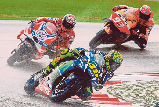 Italian riders Valentino Rossi from Movistar Yamaha (right) and Andrea Dovizioso from Ducati (middle), and Repsol Honda’s Marc Marquez (behind) at Sepang MotoGP Grand Prix.