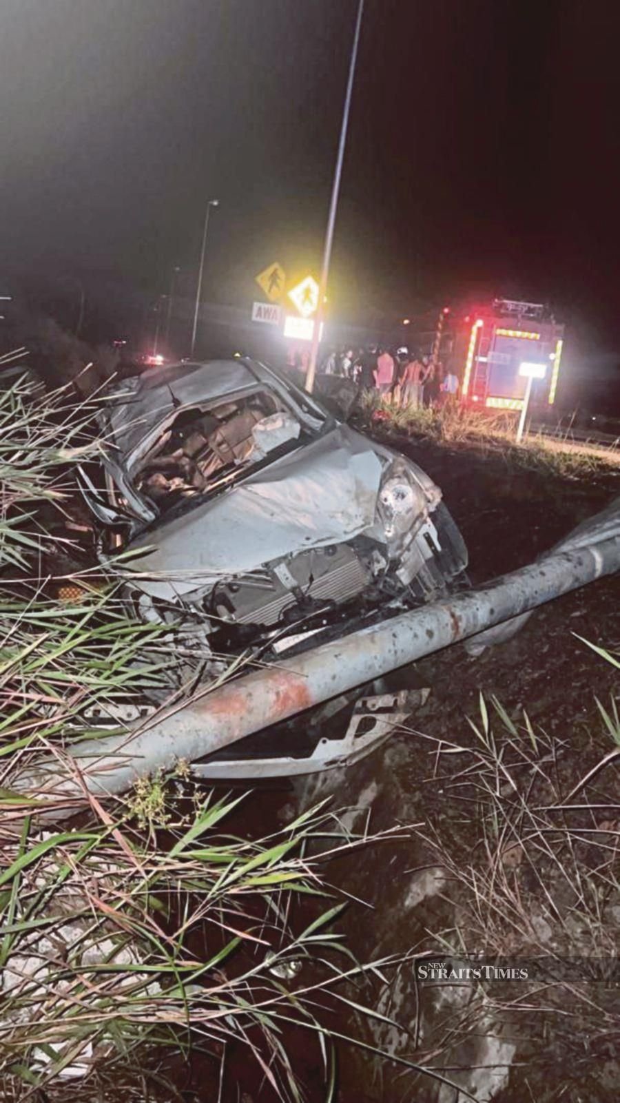 Three people were killed, while another four people including a three-year-old toddler were seriously injured when a four-wheel drive vehicle crashed into three signboards at the Pan Borneo Highway after one of its tyres exploded yesterday. Pic courtesy of Fire and Rescue Department