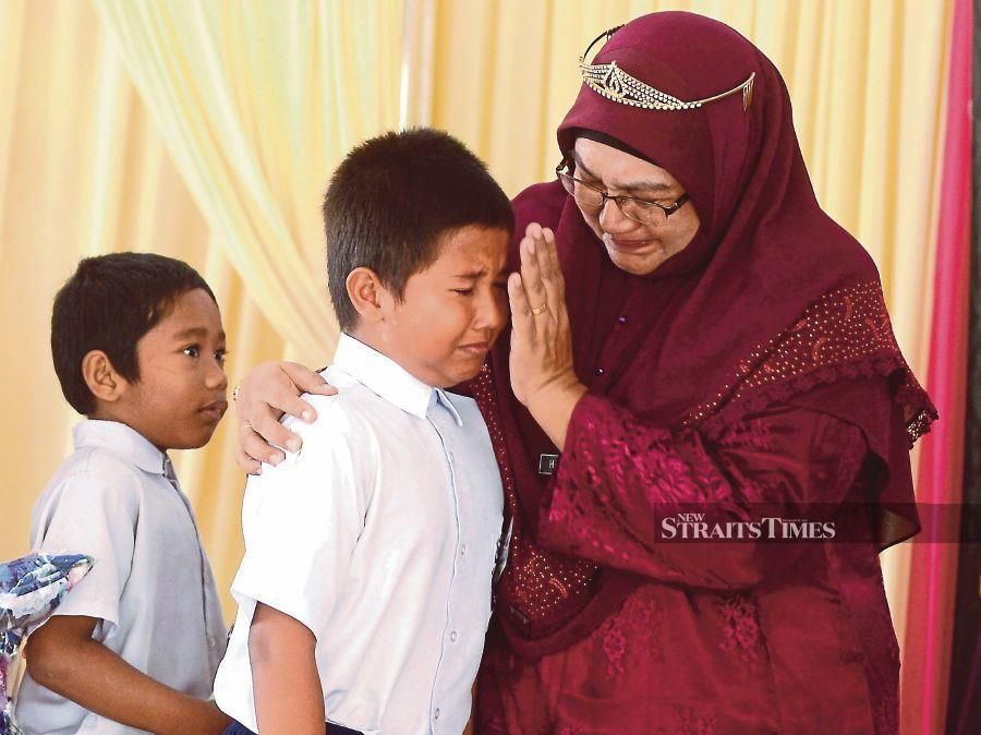 Hairunnisha Kallahan consoling a pupil at the farewell ceremony.- NSTP/Shahnaz Fazlie Shahrizal