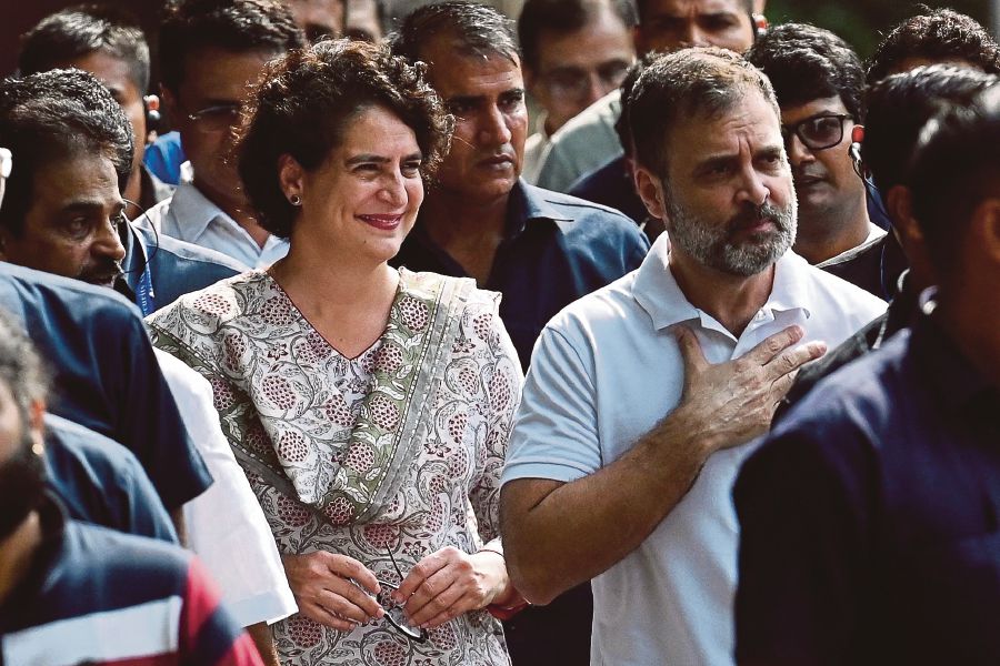 Rahul Gandhi (right) arriving with his sister, Priyanka Gandhi Vadra, at the Congress party headquarters in New Delhi on Friday, after the Supreme Court suspended his defamation conviction. AFP PIC