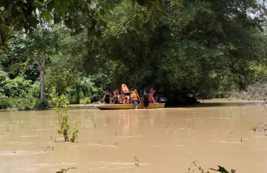 The Fire and Rescue Department rescued six families stranded in Kampung Banggol Derom here after floodwaters rose to 1.2 metres earlier in the day. PIC COURTESY OF BOMBA