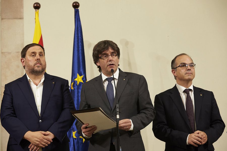 Catalonia´s Regional President Carles Puigdemont (C), next to Vice-president Oriol Junqueras (L) and conseller of Presidence Jordi Turul (R), talks to the audience after signing the approval of a referendum law on independece at Catalonia's regional Parliament in Barcelona, Spain, 06 September 2017. The Catalan Government expects to hold a referendum on independece from the central Government next 01 October 2017. The planned vote will be held with the opposition from the central government of the conservative Popular Party (PP), which has consistently appealed to the Constitutional Court to block the referendum.  EPA Photo