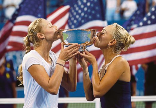 Ekaterina Makarova (left) and Elena Vesnina celebrate after beating Martina Hingis and Flavia Pennetta. Reuters pic 