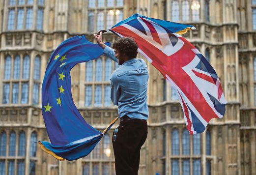 A man waving a Union flag and a European flag outside The Houses of Parliament at an anti-Brexit protest in London. With Brexit, the United Kingdom is the master of its own destiny. AFP pic 