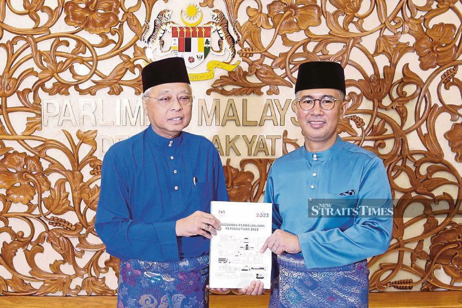Prime Minister Datuk Seri Ismail Sabri Yaakob and Finance Minister Tengku Datuk Seri Zafrul Tengku Abdul Aziz with the 2023 Budget report in Parliament yesterday. -NSTP/AIZUDDIN SAAD