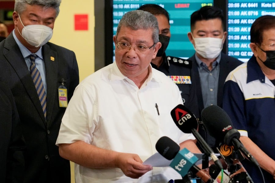 Foreign Minister Datuk Seri Saifuddin Abdullah speaks during a press conference after Malaysian youths rescued from human traffickers in Cambodia arrived at the Kuala Lumpur Airport Terminal in Sepang. -AP PIC