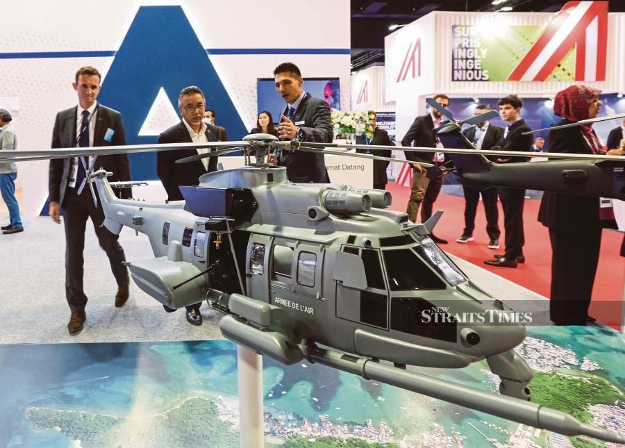 Deputy Defence Minister Adly Zahari (centre) with with Airbus Helicopters Malaysia managing director Axel De Pascal (left) and Airbus chief representative for Malaysia Burhanudin Noordin Ali at the Defence Services Asia (DSA) and National Security (Natsec) Asia 2024 exhibition.