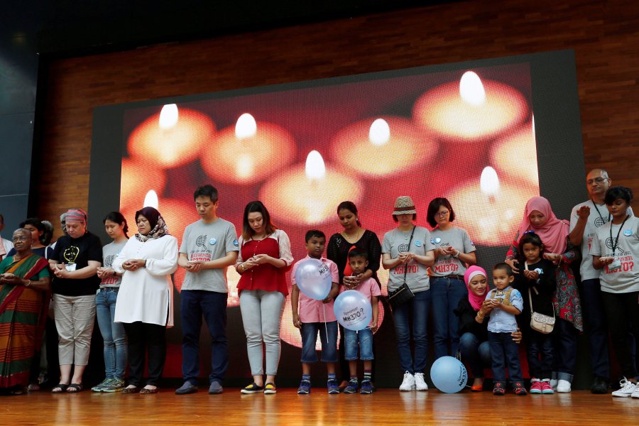 Family members hold candles during the fourth annual remembrance event for the missing Malaysia Airlines flight MH370, in Kuala Lumpur. REUTERS