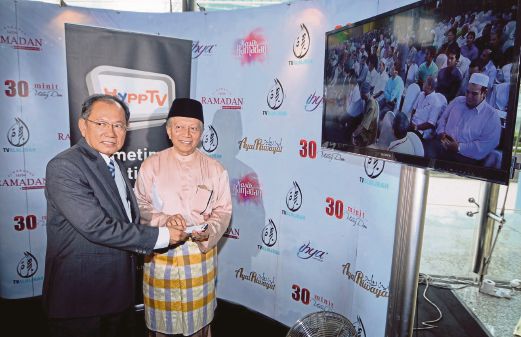 Telekom Malaysia chairman Datuk Seri Halim Shafie (left) and AlHijrah Media Corp chairman Tan Sri Mohd Yusof Noor at the launch of AlHijrah-on-Demand channel yesterday. Pic by Asyraf Hamzah