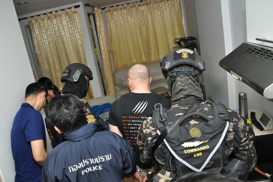 This handout taken by the Royal Thai Police on Feb 2, 2018 and received on Feb 9, 2018 shows Russian national Sergey Medvedev (C), 31, being arrested by Thai police in Bangkok for involvement in a transnational cyber crime gang. The Russian man accused of co-running a global cybercrime network shuttered in a US-led crackdown this week was arrested in Bangkok and will face extradition, Thai police said on Feb 9. (AFP PHOTO)