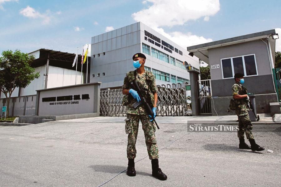 Soldiers guarding the entrance of a factory in Pedas, Rembau, on Friday, following the detection of a new Covid-19 cluster involving workers there. BERNAMA PIC