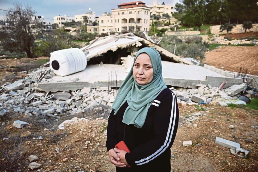 Villager Ghadeer al-Atrash standing in front of her bulldozed home in Al-Walaja, a Palestinian village in annexed East Jerusalem, on Dec 28. AFP PIC