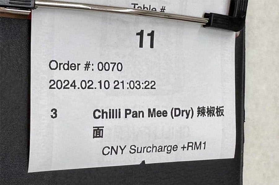 At the top of the thread under r/malaysia, a picture posted by @nuaxiem showed that RM1 “CNY Surcharge” was charged to an unknown customer after ordering three plates of Chilli Pan Mee at an unnamed eatery. PIC CREDIT TO REDDIT