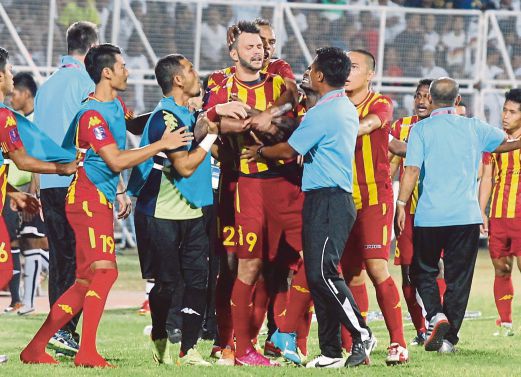 Selangor players and officials restrain Paulo Rangel (centre) after the striker was shown a red card in their match against Terengganu in Kuala Terengganu yesterday. Pic by Rozainah Zakaria