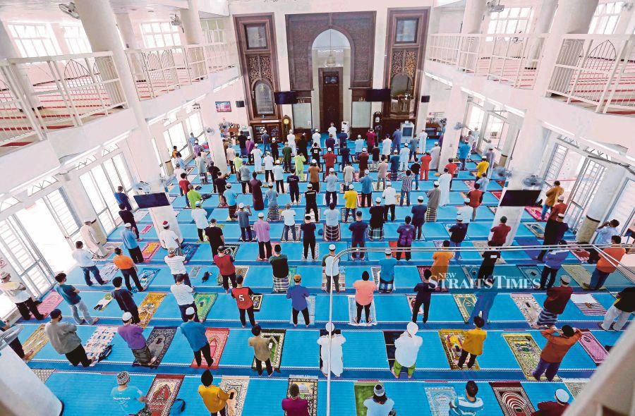 Muslims performing Friday prayers while adhering to the one-metre physical distancing requirement in Masjid Al Najihin, Kuala Lumpur, last year. -NSTP File Pix