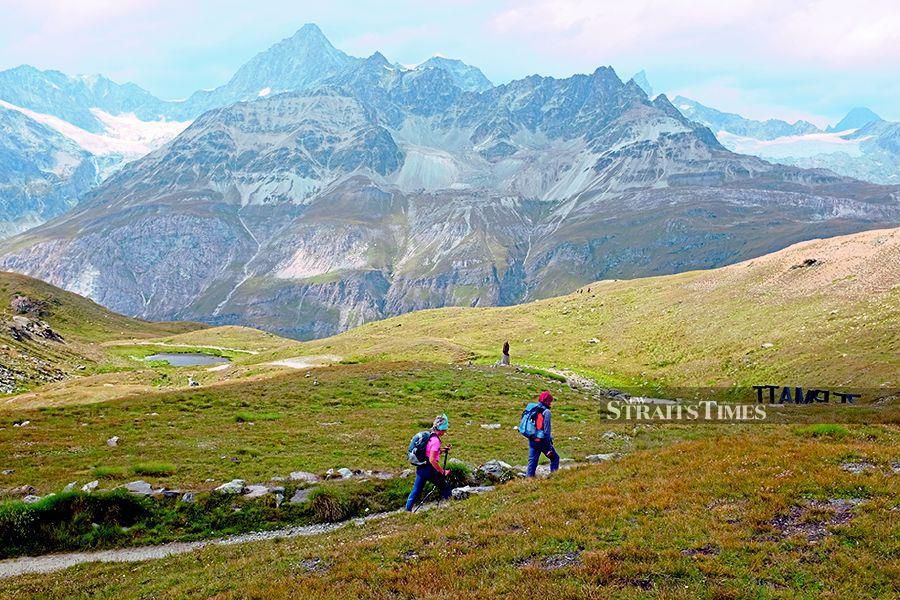 Hikers taking the famous Matterhorn’s Five Lakes trail.