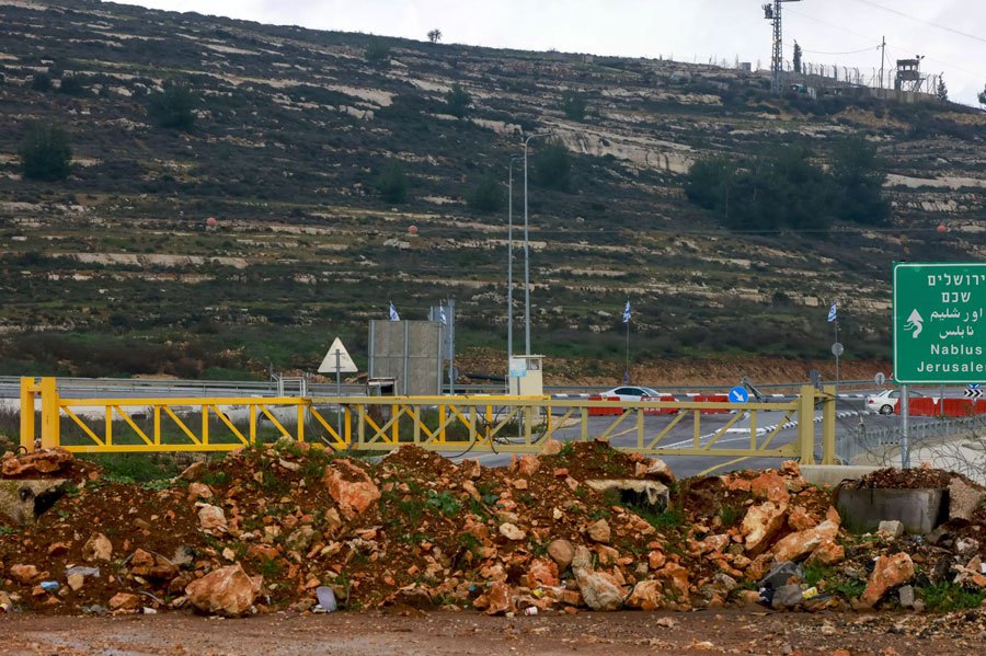 A metal barrier, piles of rocks and earth block the road between Ramallah and the West Bank city to Nablus. AFP FILE PIC