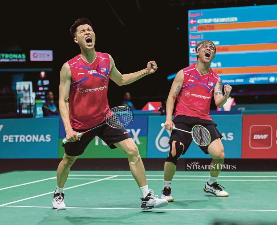 Ong Yew Sin (left) and Teo Ee Yi celebrating after beating Denmark’s Kim Astrup-Anders Skaarup Rasmussen in the Malaysia Open yesterday. BERNAMA pic 