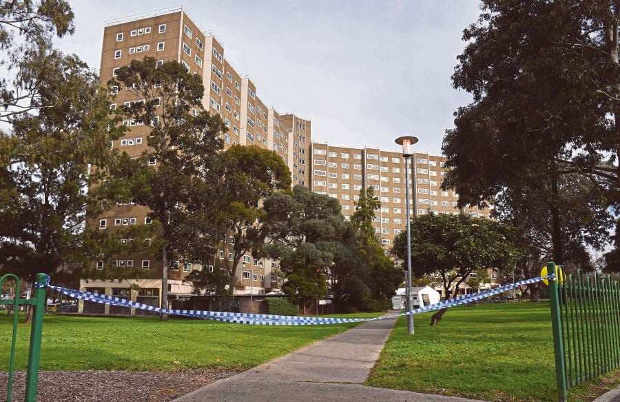 A police tape   blocking  an entrance to  a public housing estate, which is on  lockdown in Melbourne.  