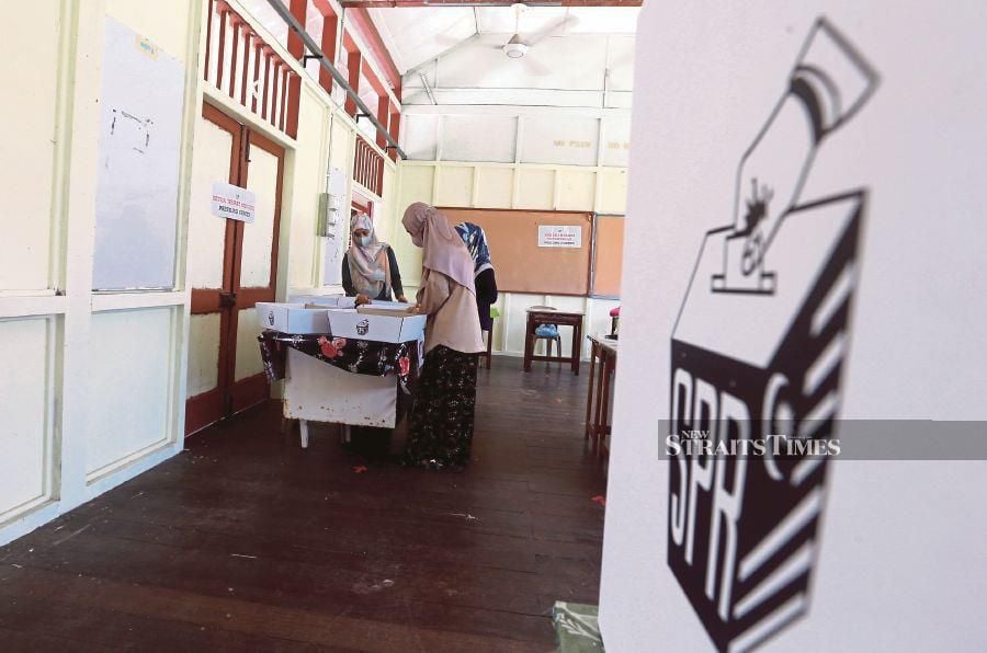 Final checks being made by Election Commission officials yesterday for the Johor state election at one of the polling centres. -NSTP/HAIRUL ANUAR RAHIM